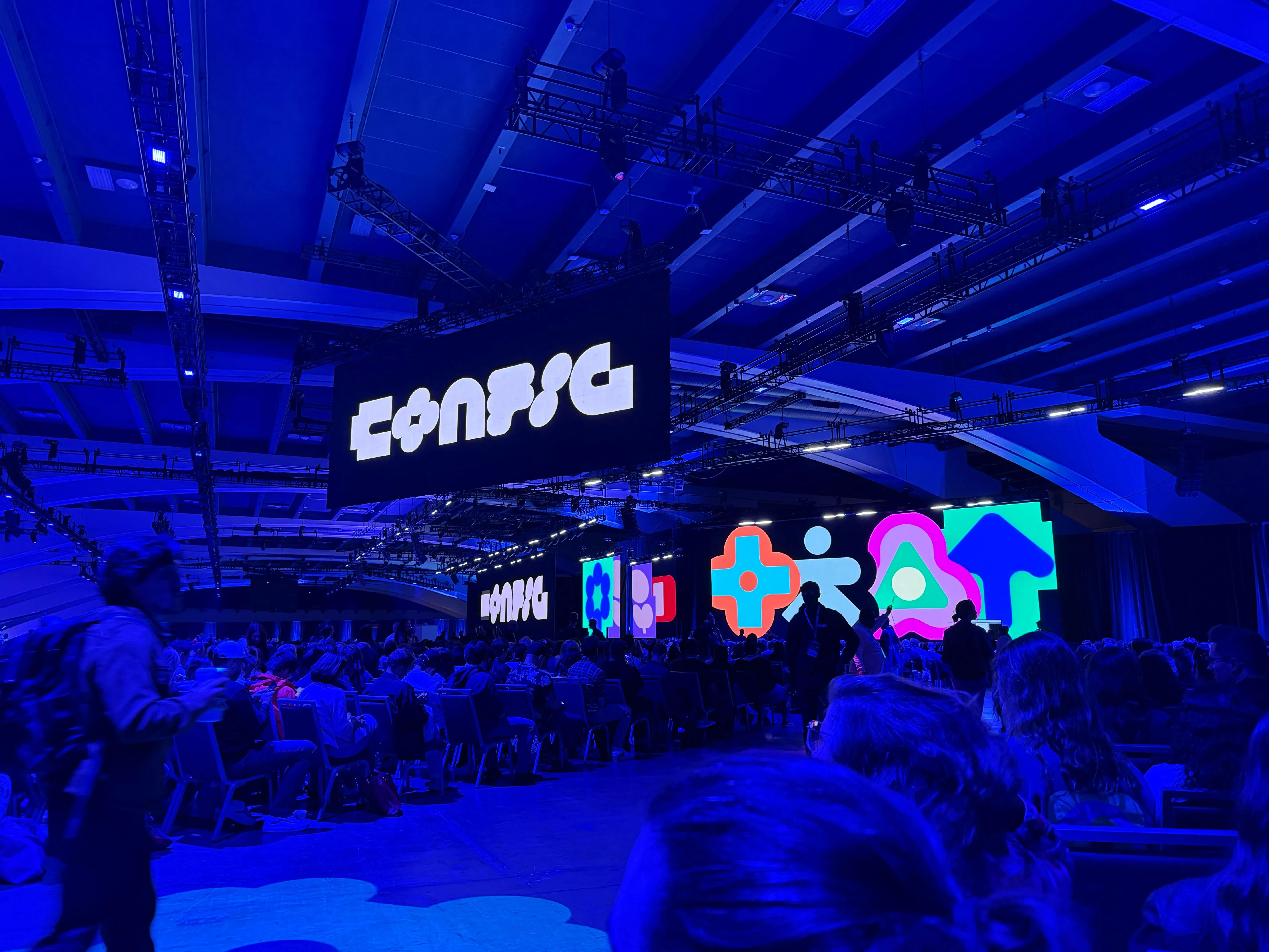Thousands of people at Config bathed in blue light
